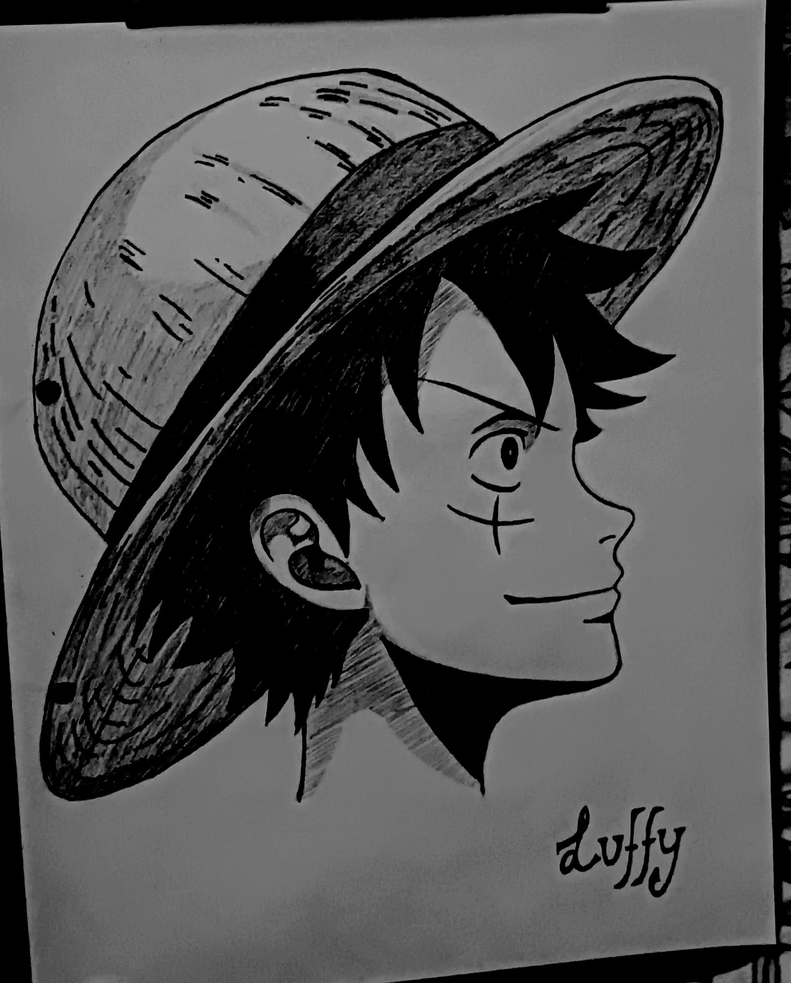 Monkey D Luffy side profile pencil sketch from One Piece showing straw hat, mild smile and scar under the eye with detailed shading